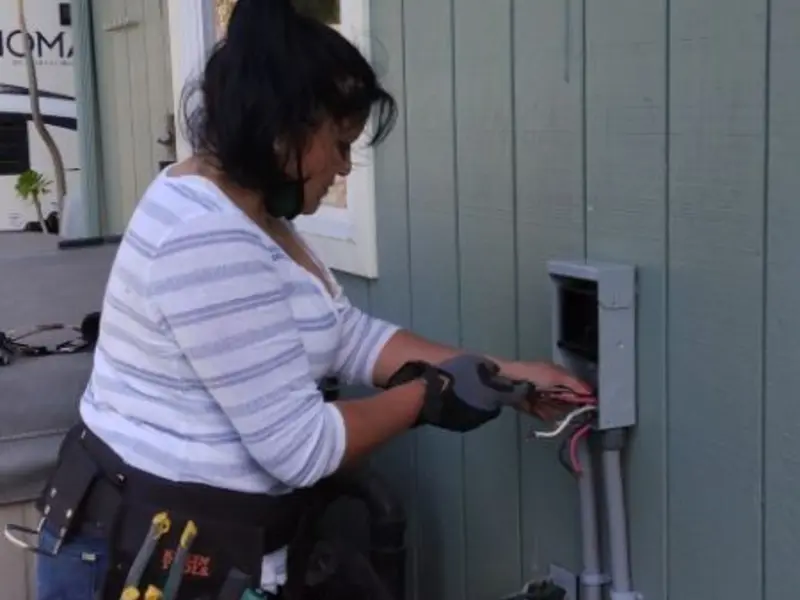 Licensed electrician wiring an exterior subpanel in Moore